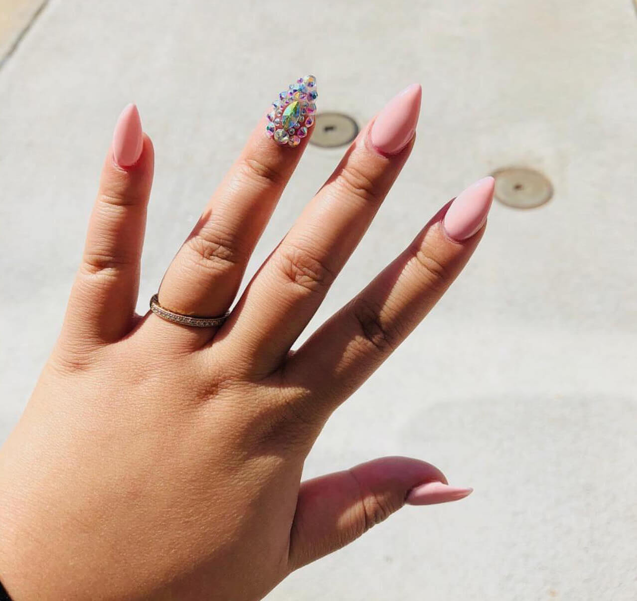 Pink acrylic nails with detailed accent art